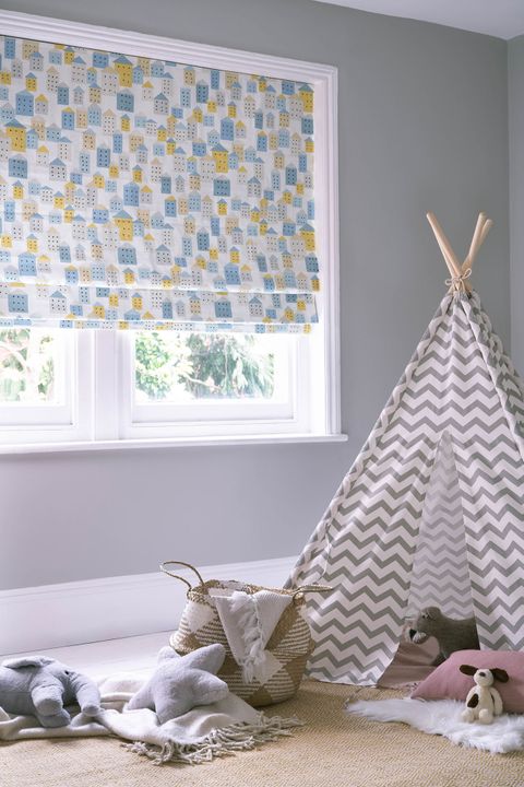 Children bedroom window dressed with roman blinds featuring Blue, grey and beige square design on a white background