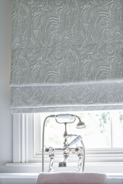Close up of Siver marble effect Roman blinds in a bathroom