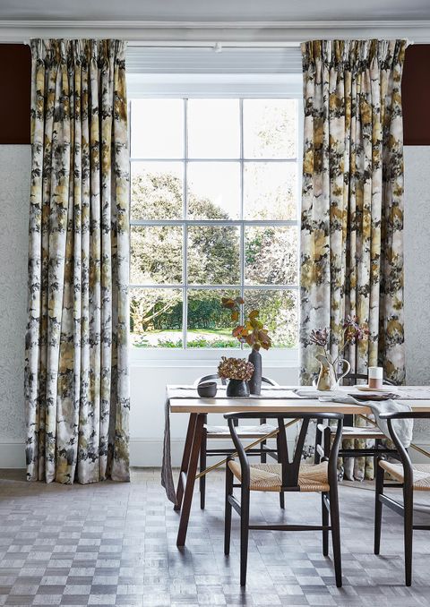 Dining room with Georgian windows and brown floral velvet curtains