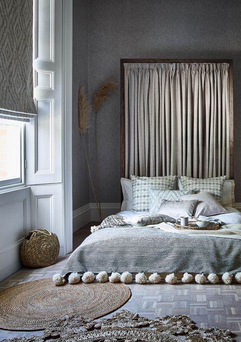 Boho bedroom with single window and curtain headboard