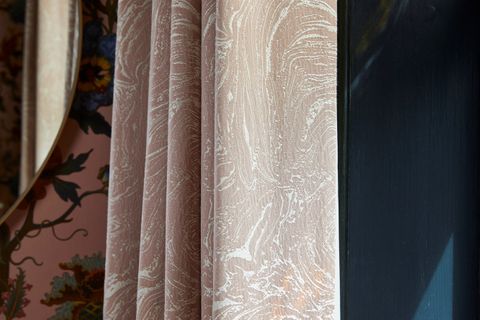 A close up shot of pink curtains featuring a subtle marble print