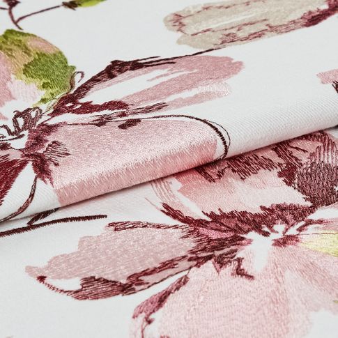 White coloured fabric with woven flowers on the material in a watercolour style