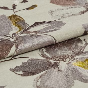 Beige coloured fabric with a flowers in a watercolour style that pattern the fabric