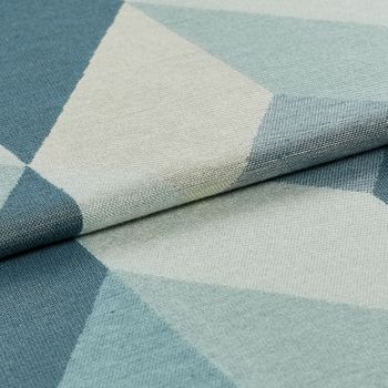 Material patterned with a repeating geometric design in shades of dark blue, light blue and white 