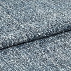 White coloured fabric designed with shades of light and dark blue which creates a distressed look to the fabric