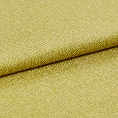 The yellow Lindora Husk fabric with a fold