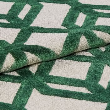 White fabric that is designed with a repeating green braid pattern