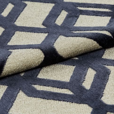 Cream fabric with a repeating dark blue geometric pattern