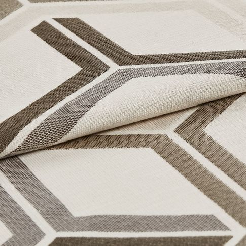 White fabric featuring a geometric design in grey and brown that repeats across the material