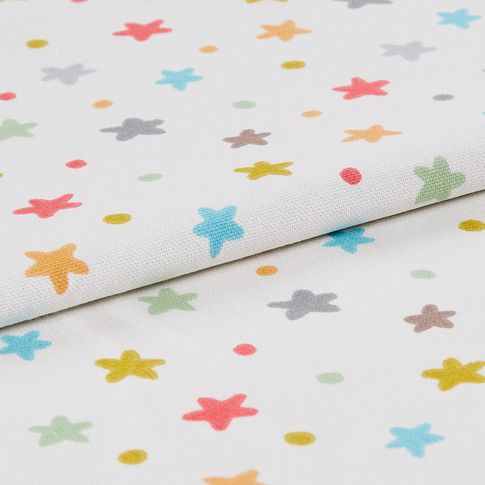 White fabric featuring a repeating pattern of dots and stars in a range of colours