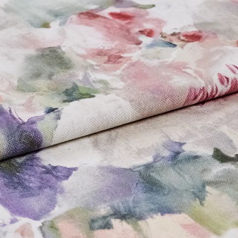 fabric decorated with flowers in a variety of colours in a watercolour style 