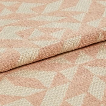 Folded over material which is designed in cream and light pink in a repeating geometric pattern
