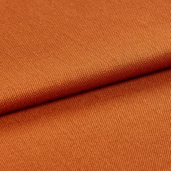 Folded over fabric that is decorated in a warm orange colour