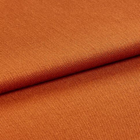 Folded over fabric that is decorated in a warm orange colour