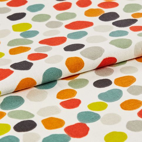 Repeating multi coloured spots on white fabric