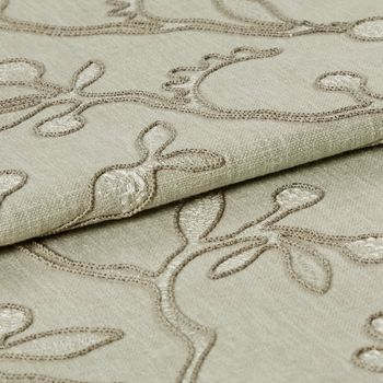 Neutral coloured fabric which has been folded is decorated with a repeating leaf and stem design