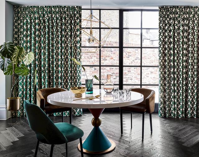 Luxe dining room with crittall doors and green geometric print curtains