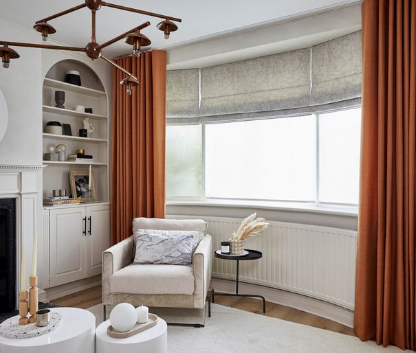 White living room with gold curtains