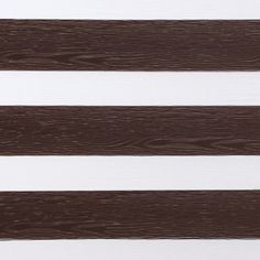 Daybreak brown which is a dark brown wood textured swatch that is striped with white 