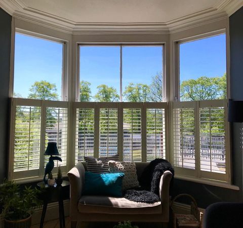 white cafe style shutters in a living room