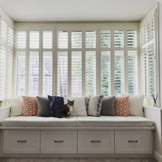 windows in bed room dressed with shutters