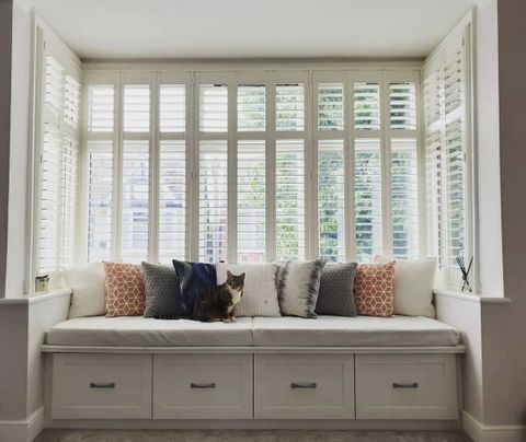 windows in bed room dressed with shutters