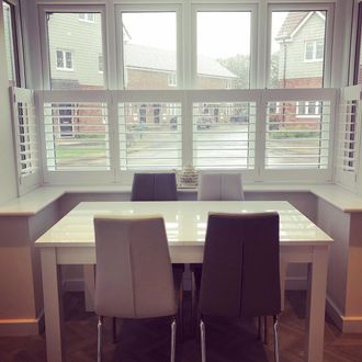 white cafe style shutters in a dining room