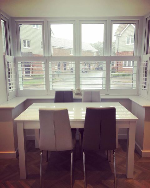 white cafe style shutters in a dining room
