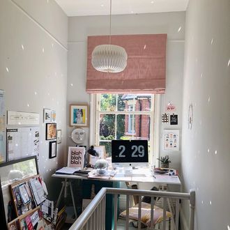 pink roman blinds hanging on window of home office