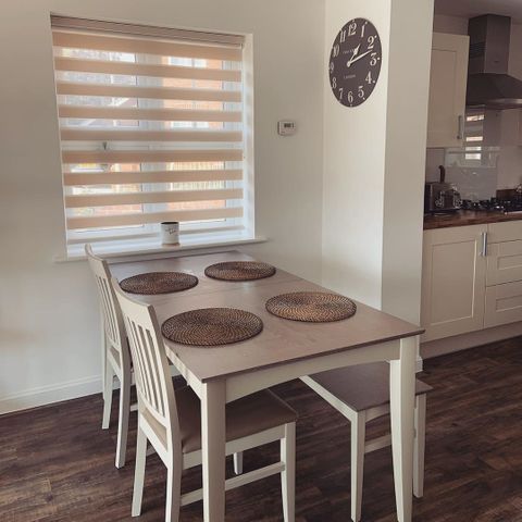 Kitchen space with dining table rustic modern style, window findow day and night blinds in a cream colour