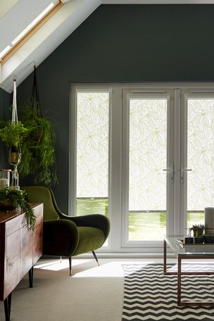 White tropical print roller blinds hanging on patio doors of living room