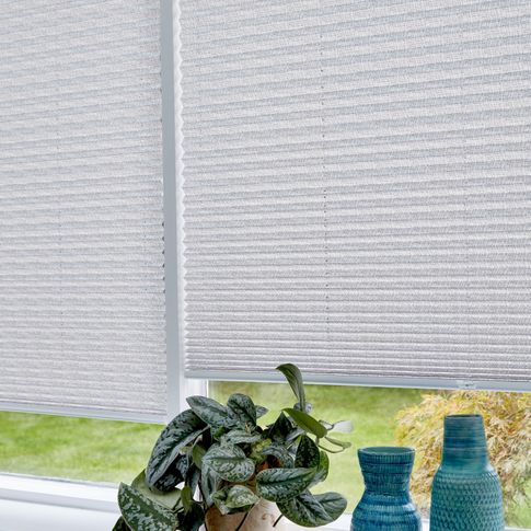 Close up of light grey Pleated blinds dressed on conservatory windows.