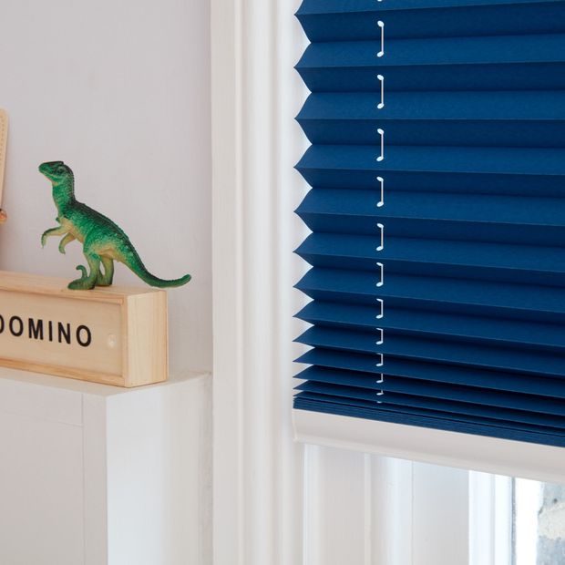 Close up of dark blue Pleated blinds dressed on the windows of kids' bedroom.