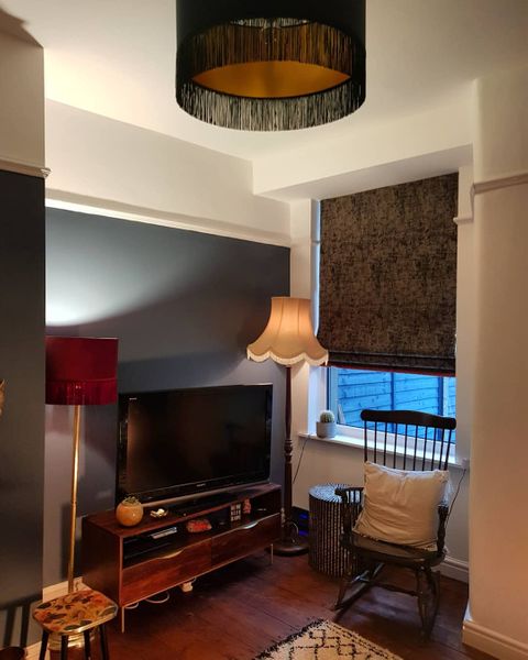 Dark grey textured roman blinds dressed on window in living room