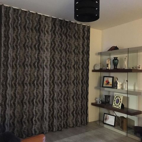 front on shot from living room of closed tribal style black and white print curtains 