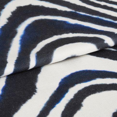 Kovu batik fabric swatch featuring zebra line print on dark blue background