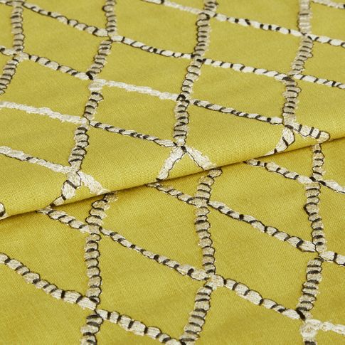 Vedra  Amarilla fabric swatch featuring hand embroidery on yellow background