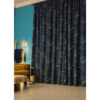 Light and dark blue print curtains hanging on windows of living room
