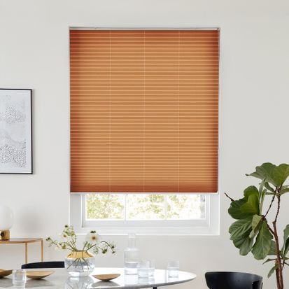 Copper gold pleated blind dressed on window
