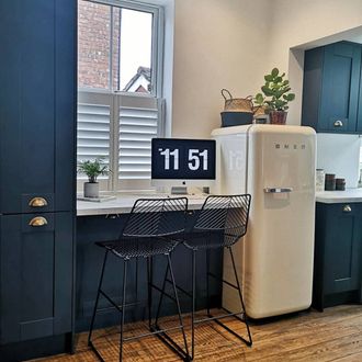 Pure White shutters in blue kitchen with bar stools