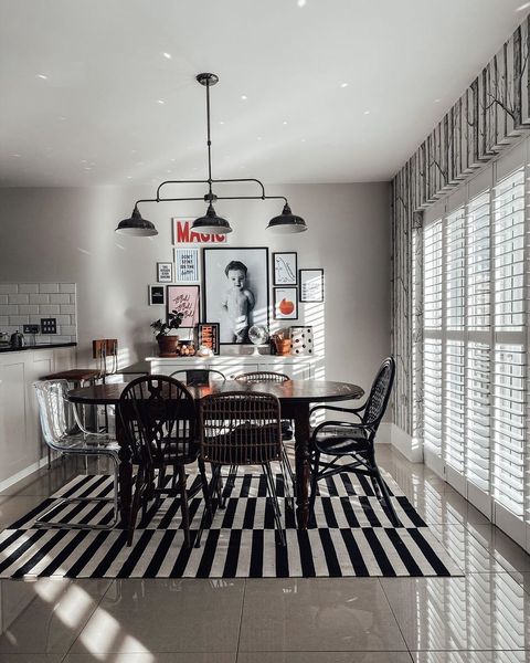 Pure white tracked shutters in monochrome dining room