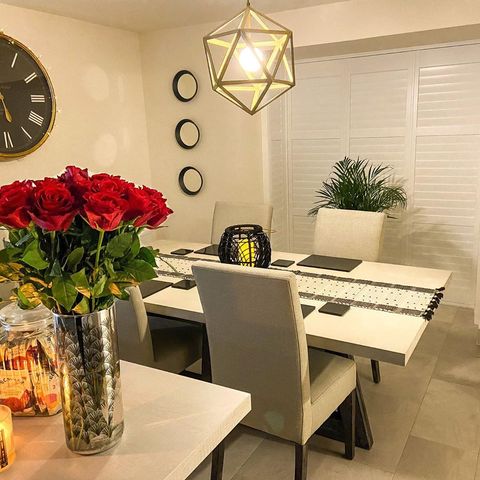 Extra white tracked shutters in dining room