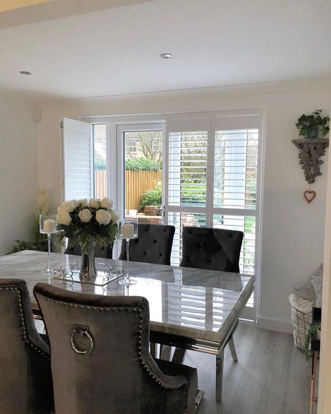 Silk white tracked shutters in dining room