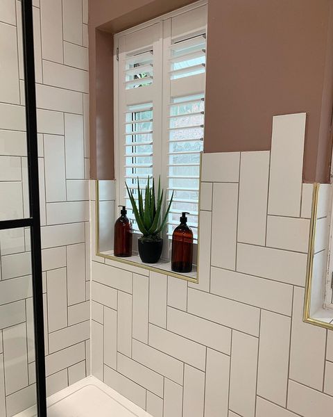 Pure white shutters on small window in newly refurbished bathroom