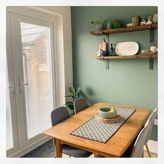 Snowflake perfect fit venetian on French doors with green wall and wooden table with fruit bowl