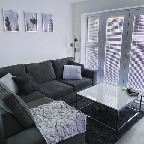 Perfect Fit venetians with marble coffee table and dark grey sofa with grey cushions