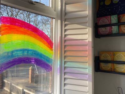 customer shutters image with vibrant rainbow painted on the window