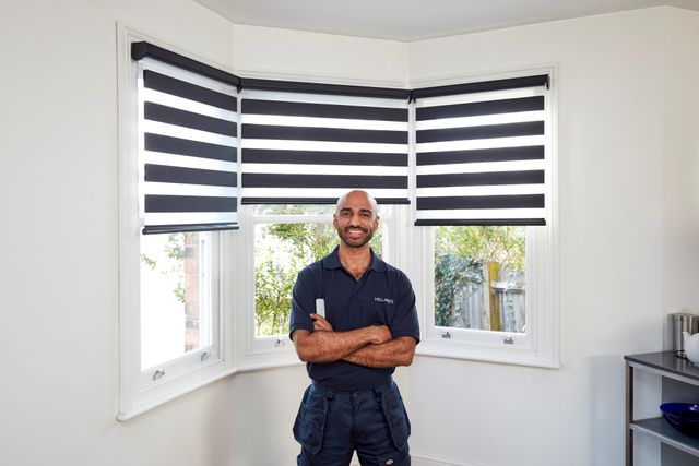 Advisor in front of blue and white striped smart blinds