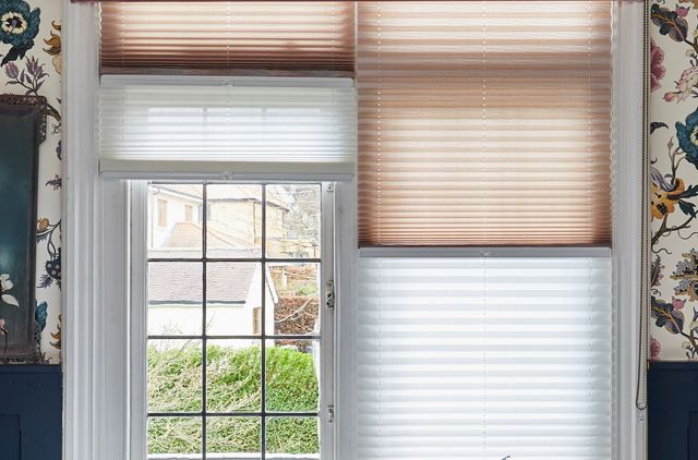 pleated transition blinds displaying both cream and white fabrics on same window
