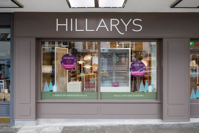 The front window display of the Hillarys showroom in Guildford which is painted in a light brown colour